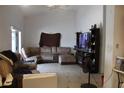 View of the living room featuring tile floors, media center, sofa, and large window at 274 W 20Th St, Apopka, FL 32703