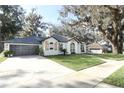 Beautiful white brick house with a well-manicured lawn and spacious driveway at 297 N Lake Jessup Ave, Oviedo, FL 32765