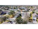 Tranquil aerial shot of a residential neighborhood with mature trees and community pond at 4012 Longworth Loop, Kissimmee, FL 34744