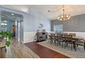 Spacious dining room features hardwood floors, a modern light fixture, and a large dining table at 4200 Bear Gully Rd, Winter Park, FL 32792