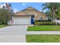 Beautiful single-story home with well-kept landscaping, a two car garage, and a bright blue front door at 4200 Bear Gully Rd, Winter Park, FL 32792