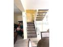 Interior view of a carpeted staircase with white railing, leading to the upper level at 4944 Sanoma Vlg # D, Orlando, FL 32808