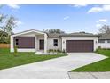 Beautiful house showcasing modern architecture, lush green lawn, and a concrete driveway at 501 Dean Creek Ln, Orlando, FL 32825