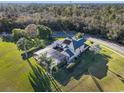 Aerial view of a spacious home with a screened-in pool area and expansive green lawn at 642 Osprey Lakes Cir, Chuluota, FL 32766