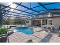 Inviting screened-in pool with ample seating and a lush backyard view at 642 Osprey Lakes Cir, Chuluota, FL 32766