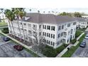 A striking exterior view displays the building's balconies, and lush landscaping and palm trees at 770 Siena Palm Dr # 201, Kissimmee, FL 34747