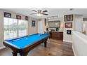 A game room featuring a pool table, a bar, and a mini fridge at 932 Classic View Dr, Auburndale, FL 33823