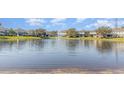 Scenic view of the community pond with fountain and surrounding homes at 1311 Travertine Ter, Sanford, FL 32771