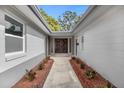 Inviting front entryway with a landscaped walkway leading to the beautiful, double front doors at 1407 Dunsany Ave, Orlando, FL 32806