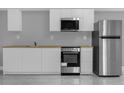 Contemporary kitchen featuring stainless steel appliances and ample counter space for food prep at 1407 Dunsany Ave, Orlando, FL 32806