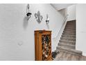 Entryway featuring stairs, a small shoe rack, and decorated white walls at 142 Villa Di Este Ter # 204, Lake Mary, FL 32746
