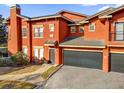 Close up on an orange painted townhouse with an attached garage at 142 Villa Di Este Ter # 204, Lake Mary, FL 32746