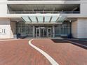 Inviting entrance featuring a glass canopy, brick paving, and well-placed benches for a welcoming atmosphere at 150 E Robinson St # 1214, Orlando, FL 32801