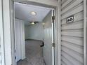 View from the doorway into a condo with neutral paint, tile flooring, and a ceiling fan at 1932 Lake Atriums Cir # 85, Orlando, FL 32839