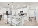 Bright kitchen features white cabinetry, stainless steel appliances, granite countertops, and a breakfast bar area at 2234 Bluebird Pl, St Cloud, FL 34771