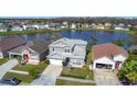 Beautiful aerial view of a gray two-story home with scenic lake view at 2263 Mallard Creek Cir, Kissimmee, FL 34743