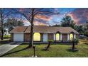Charming brick home with a well-manicured lawn and a classic design with white trim around the windows at 23940 Oak Ln, Sorrento, FL 32776