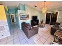 Bright living room featuring neutral tile floors, modern lighting, and sliding glass doors to the outside at 281 San Gabriel St, Winter Springs, FL 32708