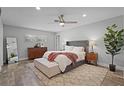 Serene main bedroom features neutral tones, a ceiling fan, and wood-look flooring at 322 Nelson Ave, Longwood, FL 32750