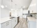 Modern kitchen with island, quartz countertops, stainless appliances, and tile backsplash at 333 Bahia Cir, Longwood, FL 32750