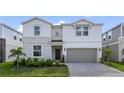 Beautiful two-story home boasts stone accents, manicured landscaping, and a two-car garage at 4157 Lana Ave, Davenport, FL 33897