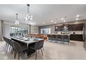 Open-concept living space featuring modern kitchen, dining area, and cozy living room at 4157 Lana Ave, Davenport, FL 33897