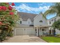 Charming two-story home with manicured lawn, two-car garage and mature trees adding curb appeal at 421 E Gore St, Orlando, FL 32806