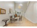 Bright living room featuring a staircase, a fireplace and an adjacent sitting area with a grand chandelier at 421 E Gore St, Orlando, FL 32806
