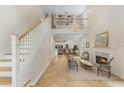 Bright living room featuring a staircase, a fireplace and an adjacent sitting area with a grand chandelier at 421 E Gore St, Orlando, FL 32806