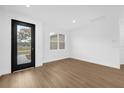 Bright and airy living room features stylish flooring, fresh white paint and ample natural light at 4944 Tinkham Ave, Orlando, FL 32812