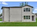 Two-story home with large windows providing ample natural light and a well-manicured lawn at 495 Dean Creek Ln, Orlando, FL 32825