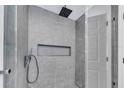 Modern tiled shower featuring a rainfall shower head and glass door at 6593 Queens Borough Ave # 202, Orlando, FL 32835