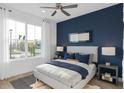 Comfortable bedroom with a large window for natural light, complemented by modern decor at 6744 Willow View Ave, Orlando, FL 32829