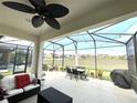 The screened lanai features ample seating, a ceiling fan and expansive views of the neighborhood at 7035 Oxbow Rd, Minneola, FL 34715