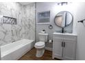 Bathroom featuring a marble tiled shower and modern fixtures at 812 S Locust Ave, Sanford, FL 32771