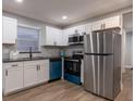 Well-lit kitchen featuring stainless steel appliances and modern cabinetry at 812 S Locust Ave, Sanford, FL 32771