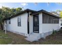 Side exterior of home with a screened-in porch and an entry door at 812 S Locust Ave, Sanford, FL 32771
