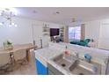 A view of the living room showcasing an open floor plan to the kitchen and dining area at 974 Leeward Pl # 205, Altamonte Springs, FL 32714