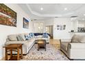 Comfortable living room with tile flooring, neutral paint, a ceiling fan, and an open layout blending living and dining spaces at 10144 Lake Miona Way, Oxford, FL 34484