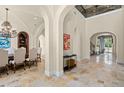 Elegant foyer with stone floors, arched doorways, and soaring ceilings creates a grand entrance at 11324 Bridge House Rd, Windermere, FL 34786