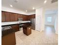 Well-equipped kitchen featuring stainless steel appliances and dark wood cabinets at 12615 Salomon Cove, Windermere, FL 34786