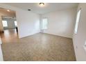 Bright living room with tile flooring and natural light from two windows at 12615 Salomon Cove, Windermere, FL 34786