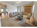 Bright living room featuring tile floors, modern sofa, and stylishly illuminated wine storage at 12615 Salomon Cove, Windermere, FL 34786