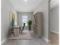 Cozy home office featuring wood-look tile, a desk, chair, and a bookshelf at 18955 Rawson St, Orlando, FL 32827