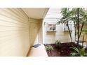 Entrance to the condo with an open air atrium and a well-lit walkway at 1948 Lake Atriums Cir # 113, Orlando, FL 32839