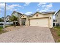 Charming single-story home with a brick paved drive and two-car garage at 2797 Monticello Way, Kissimmee, FL 34741