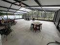 A screened outdoor area with tables, seating, and ceiling fans, creating an inviting space for leisure at 322 N Shadowbay Blvd, Longwood, FL 32779