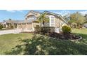 View of the front of the house showing lawn, landscaping, and front entrance at 3262 Amaca Cir, Orlando, FL 32837