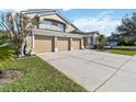 Charming two-story home with a three-car garage, showcasing a well-kept lawn and appealing landscaping at 3262 Amaca Cir, Orlando, FL 32837