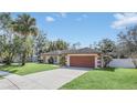 Lovely single-story home with a spacious driveway and verdant lawn at 328 Bridle Path, Casselberry, FL 32707